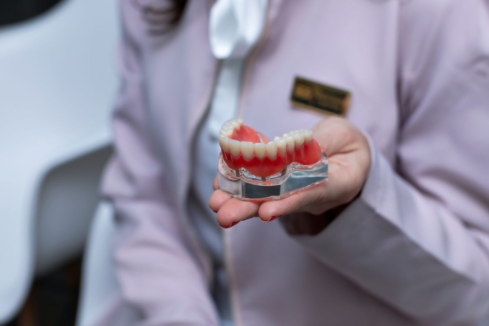 Set of dentures held in a hand